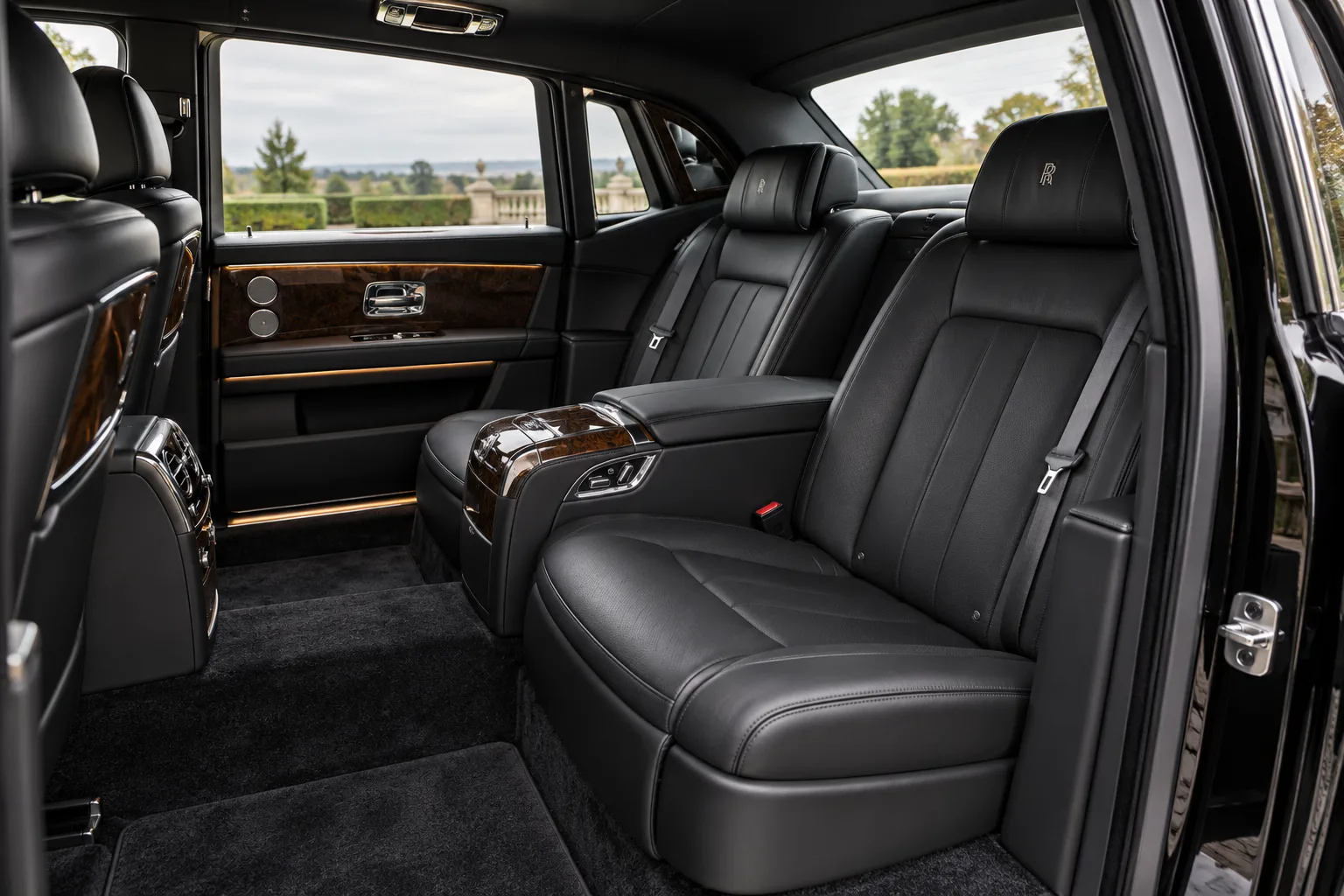 Black leather rear cabin of a Rolls-Royce seen through the open door